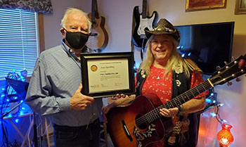 Joan holding an award