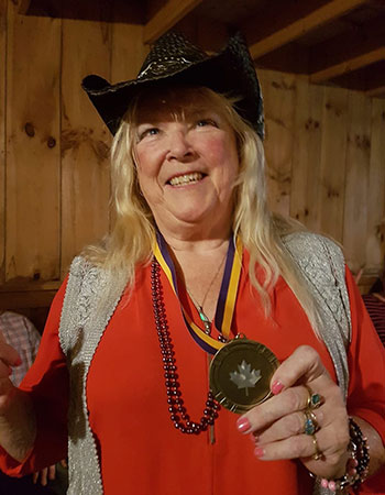 Joan holding a medal