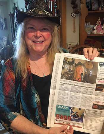 Joan showing a newspaper article