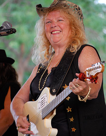 Joan playing a tan guitar